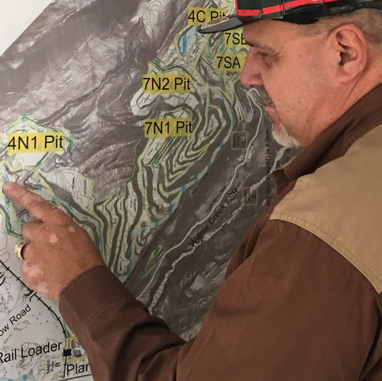 Mark Bartkoski points to a site of interest on a mining exploration/resource map.