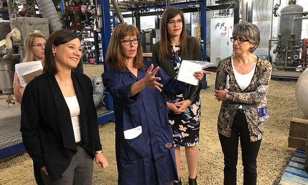L-R: Minister Shannon Phillips, Lisa Doig, MLA Jessica Littlewood and Lorraine Mitchelmore discuss the reactor process at the plant site in Fort Saskatchewan.