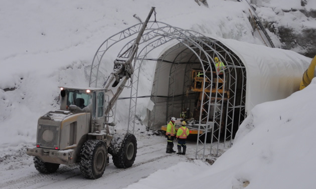 a large machine installing the framework of an entry tunnel at a mine site