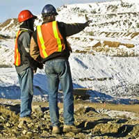 Photo of two men overlooking mining operation